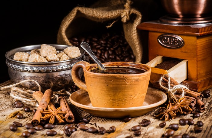 Coffee cup with beans, sugar, and spices