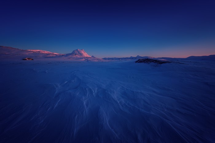 Snowy landscape in Sulitjelma, Norway during sunrise