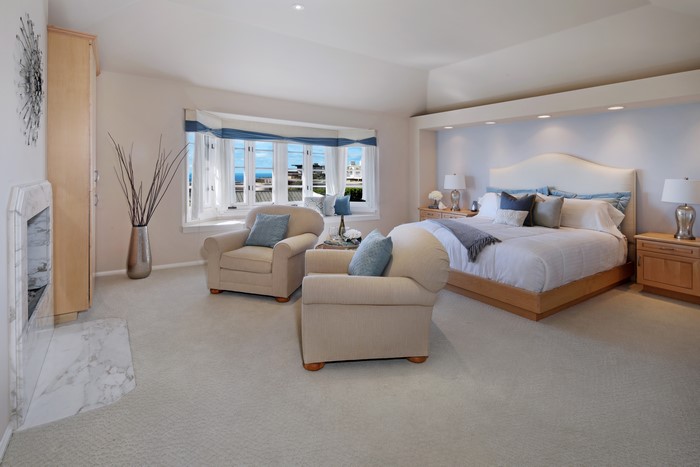Bedroom with bay window and fireplace