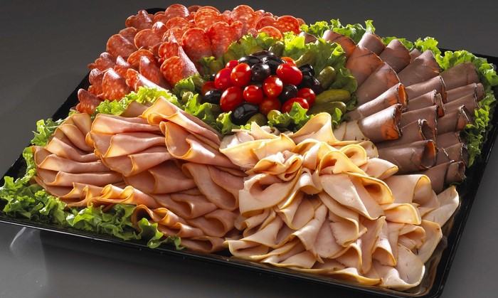 Meat and cheese platter with olives and tomatoes