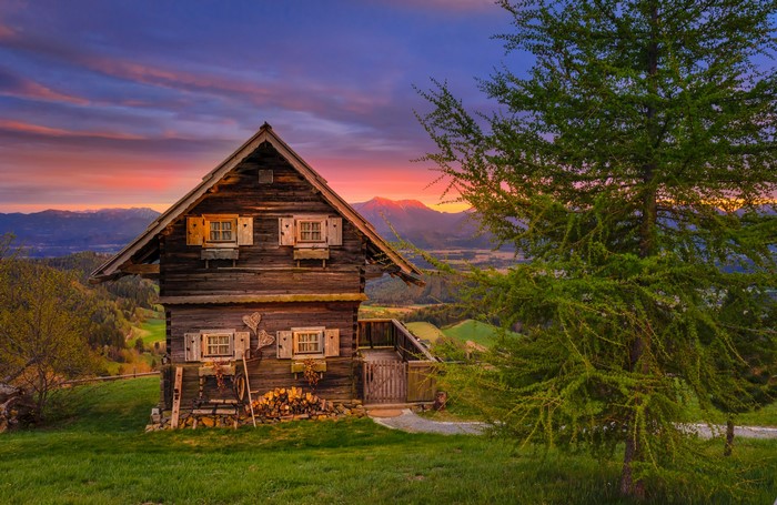Wooden house on Magdalensberg, Austria at sunset
