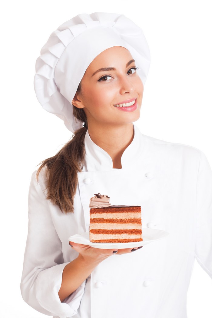 Chef holding a slice of layered cake