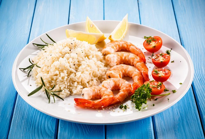 Shrimp with Rice, Tomatoes, and Lemon on a Plate