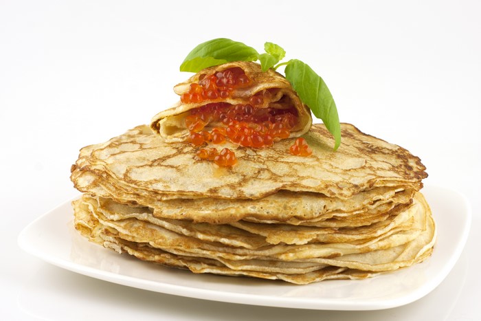 Pancakes with Caviar and Basil on a Plate