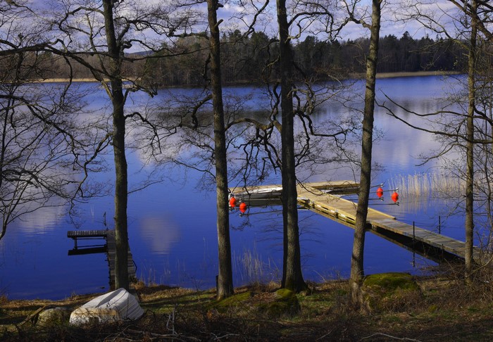 Wooden dock with orange buoys on a lake in Rimforsa, Sweden
