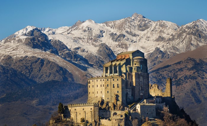 Saint Michael Abbey in Piedmont, Italy, with snowy mountains