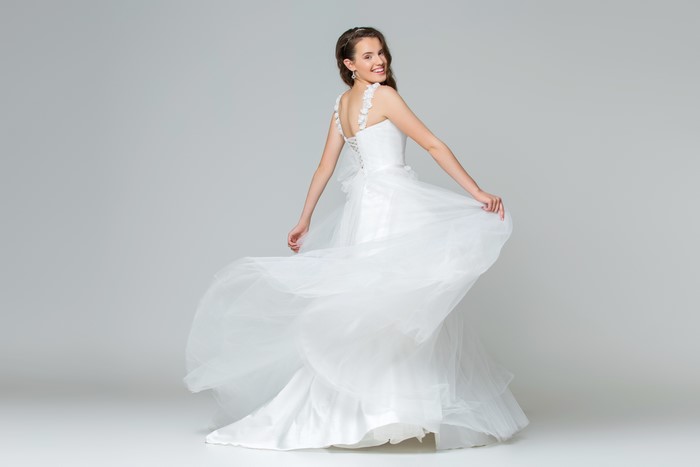 Bride in a white dress on a gray background
