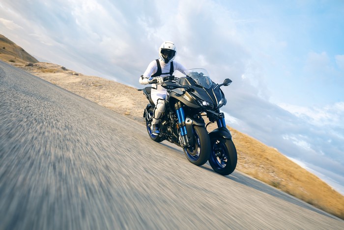 Motorcyclist on a Yamaha Niken motorcycle on a road