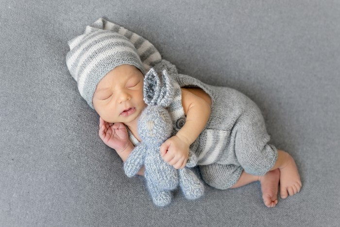 Newborn baby sleeping with a stuffed hare