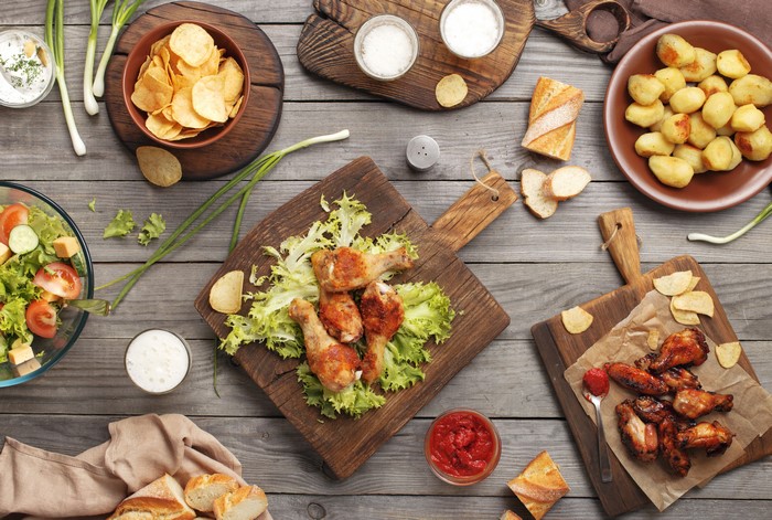 Still-life of Roast Chicken, Potato, Bread, Chips, and Salad