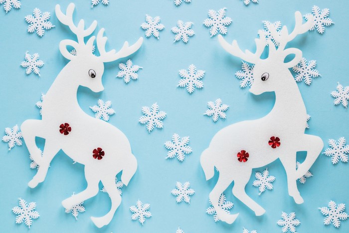 Two white reindeer decorations with snowflakes
