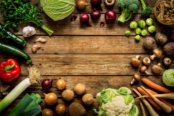 Assortment of fresh vegetables on wooden planks
