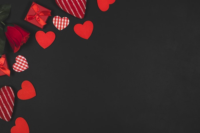 Valentine's Day red hearts and rose on black background