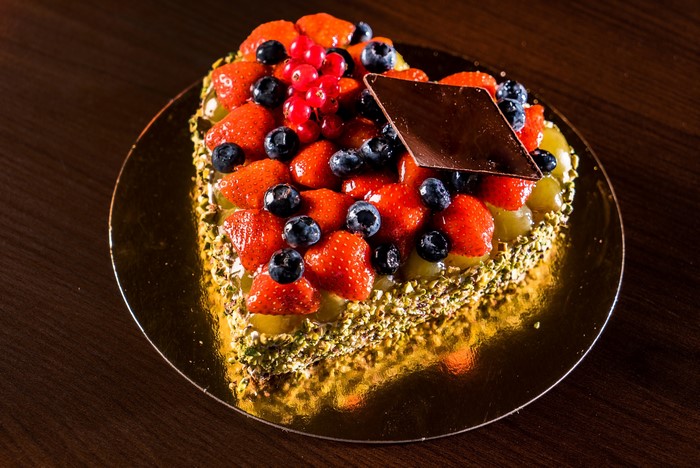 Heart-shaped fruit cake with strawberries and blueberries