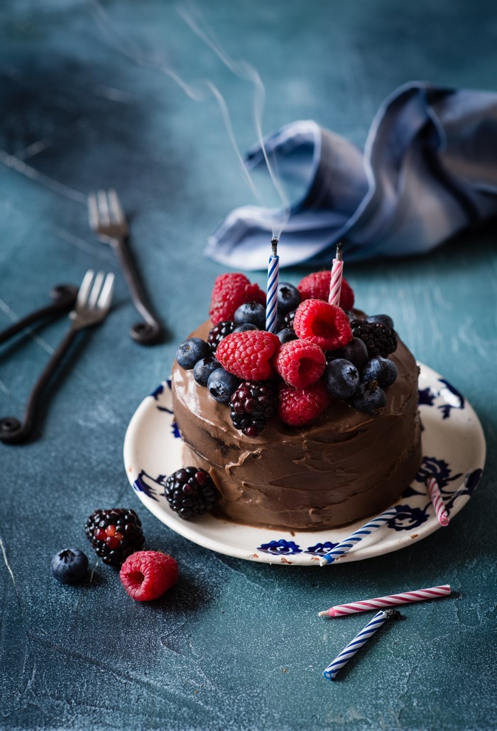 Chocolate cake with berries and candles