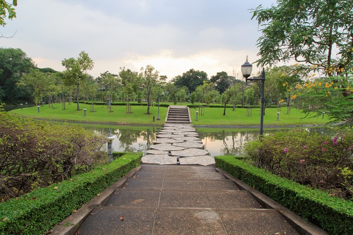 Park with pond and stone bridge in Bangkok, Thailand