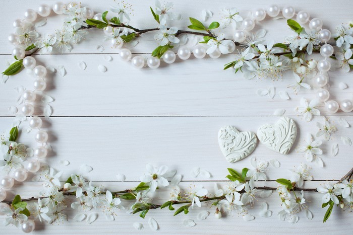 Pearl necklace and cherry blossoms on wood planks