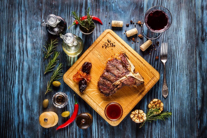 Still-life of T-bone steak with wine and spices