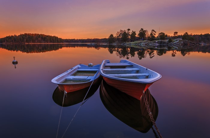 Two boats on a lake at sunset in Sweden