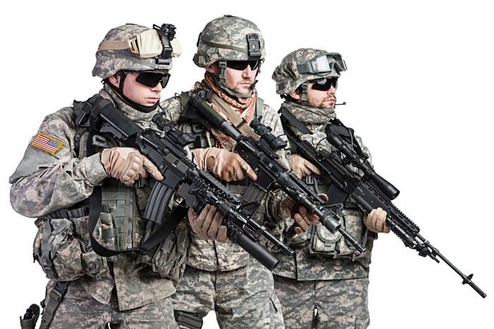 Three soldiers with assault rifles on white background