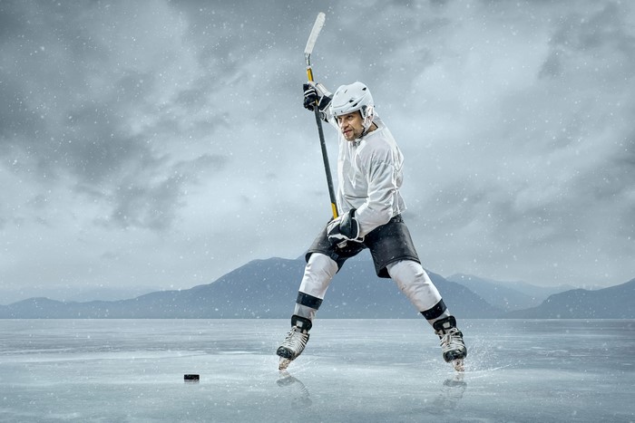 Man playing hockey on a frozen lake