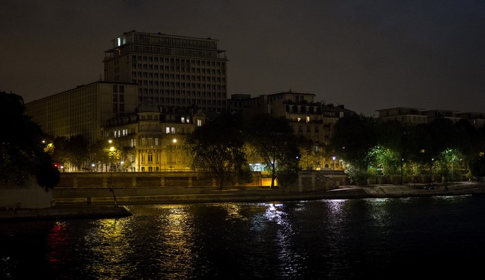 Parisian buildings and river at night
