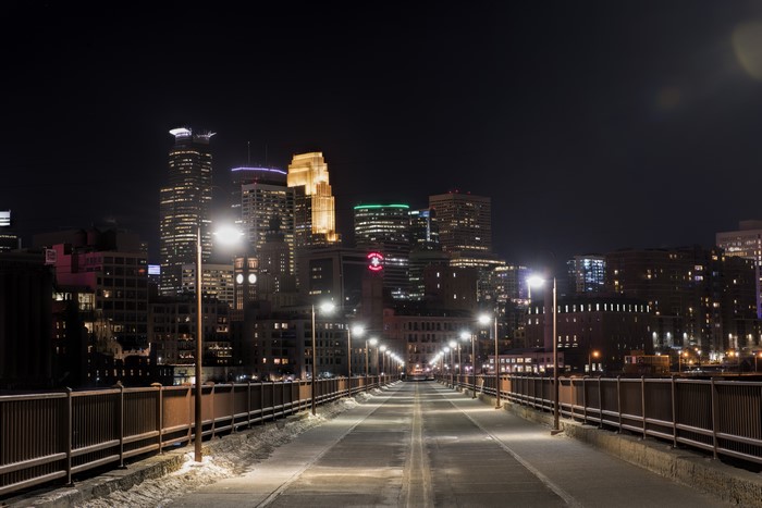 Minneapolis Minnesota skyline at night from a bridge in winter