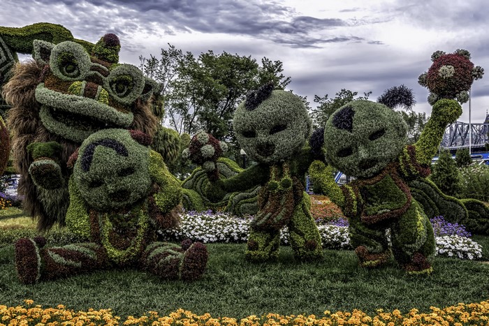 Topiary sculptures of creatures in a park