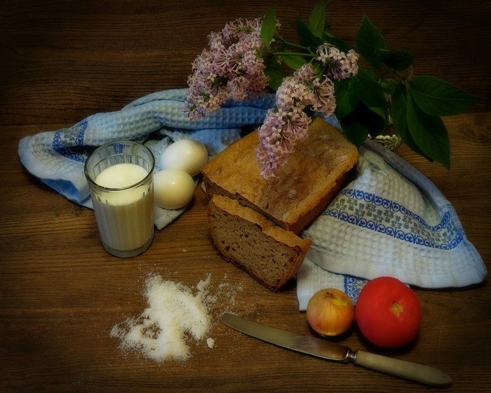 Still-life with bread, eggs, milk, tomato, onion, lilac, and knife