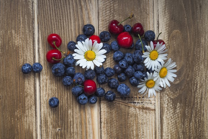 Blueberries, Cherries, and Daisies on Wood Planks