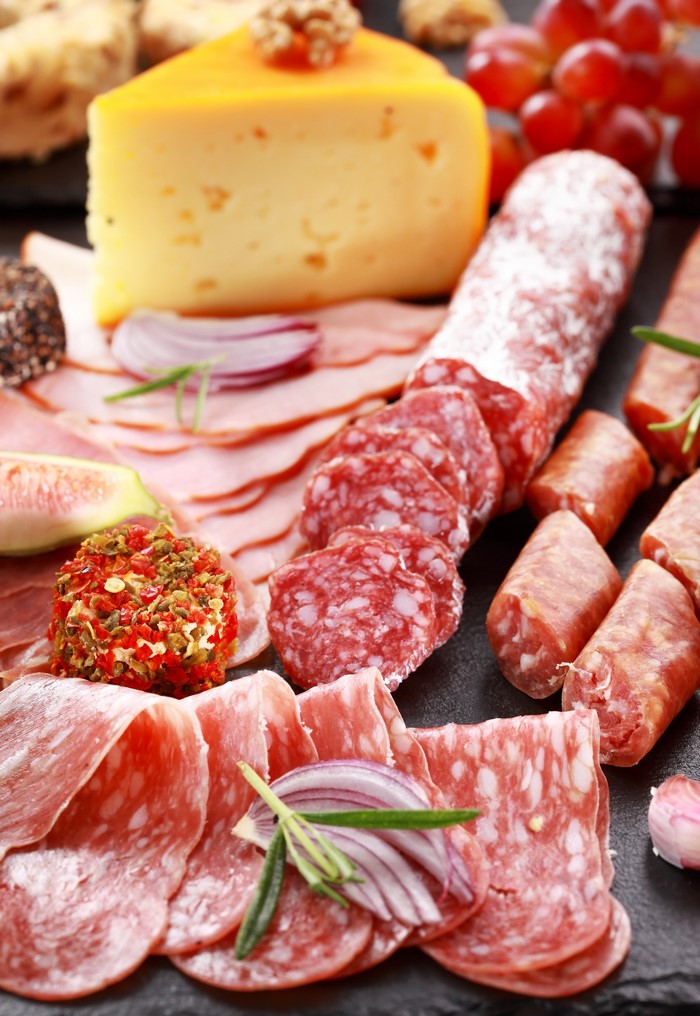 Charcuterie board with cheese, salami, and ham