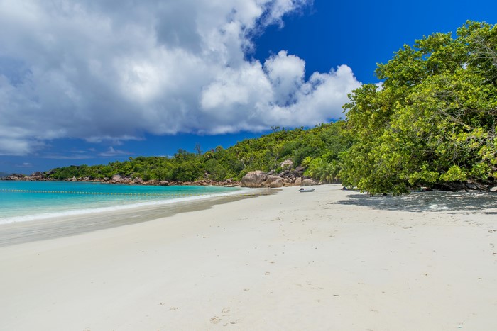 Tropical beach with turquoise water and green hills