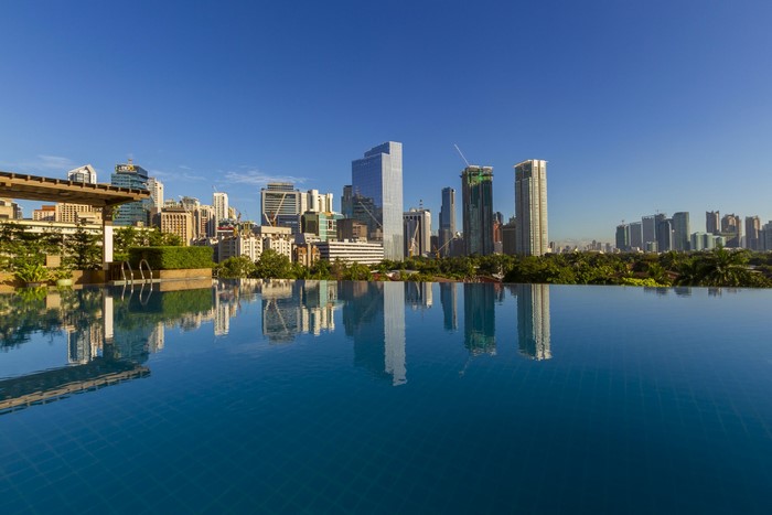 Makati City skyline reflected in an infinity pool
