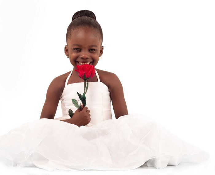 Young Black Girl in White Dress Holding a Red Rose