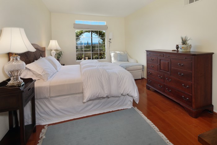 Bedroom with bed, dresser, and window view