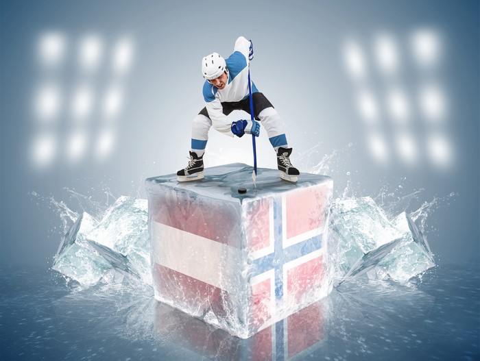 Hockey player on ice blocks with flags