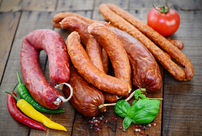 Meat products, sausages, bell pepper, and tomato