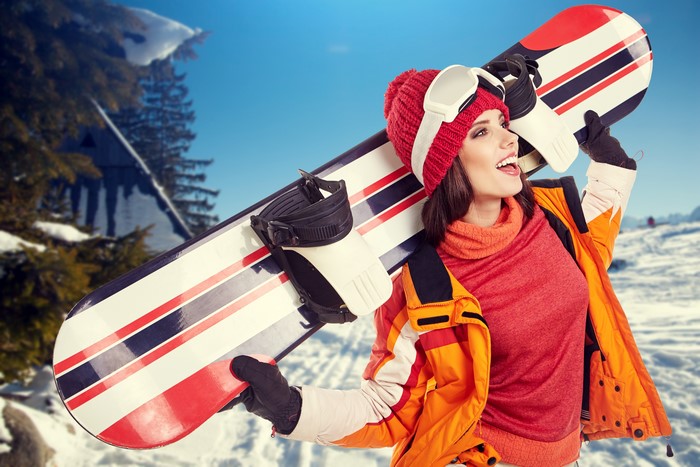 Woman with Snowboard in Winter Landscape