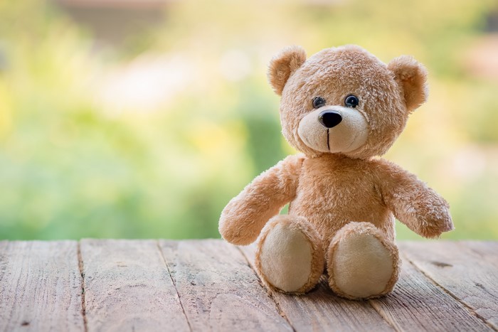 Teddy bear sitting on wood planks