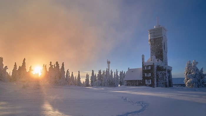 Seibelseckle, Germany: Winter sunrise over snow-covered spruce trees and tower