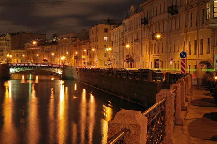St. Petersburg canal at night with bridge and buildings