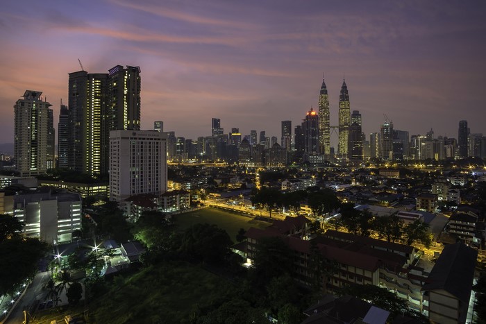 Kuala Lumpur skyline at dusk with Petronas Towers