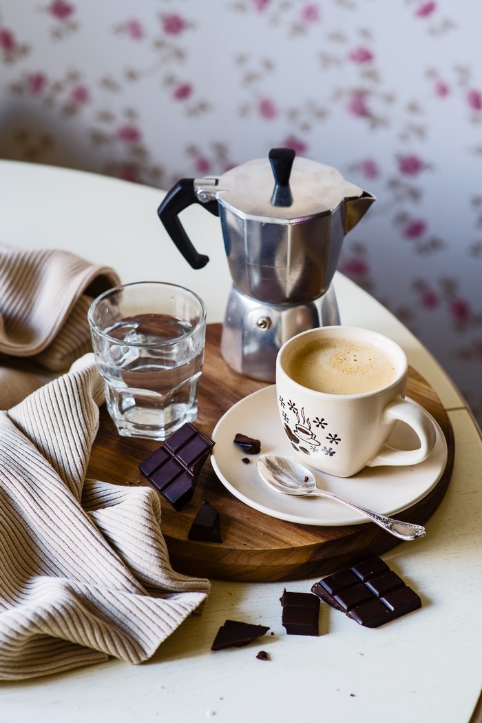 Coffee, chocolate, and water on a wooden board