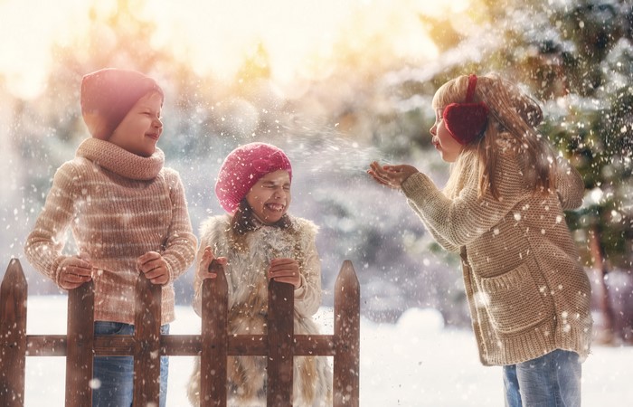Three children playing in the snow