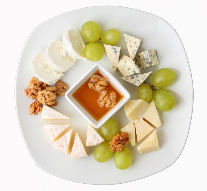 Cheese, Grapes, Nuts, and Honey on a Plate