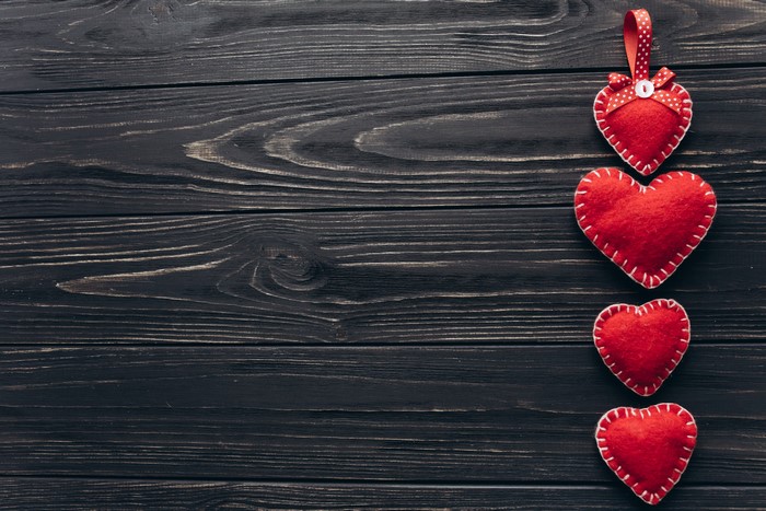 Four Red Hearts on Dark Wood Planks