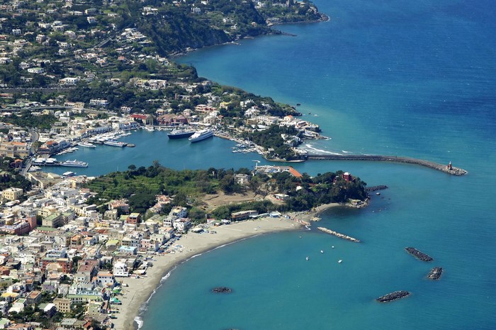 Aerial view of Ischia, Italy coast with marina and houses