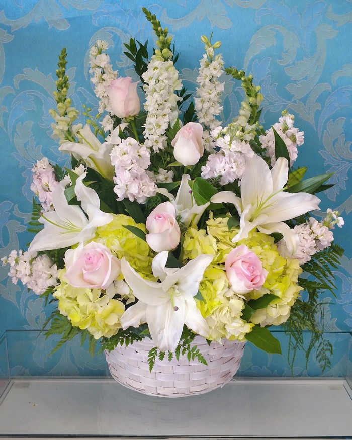 White and pink floral arrangement in a basket