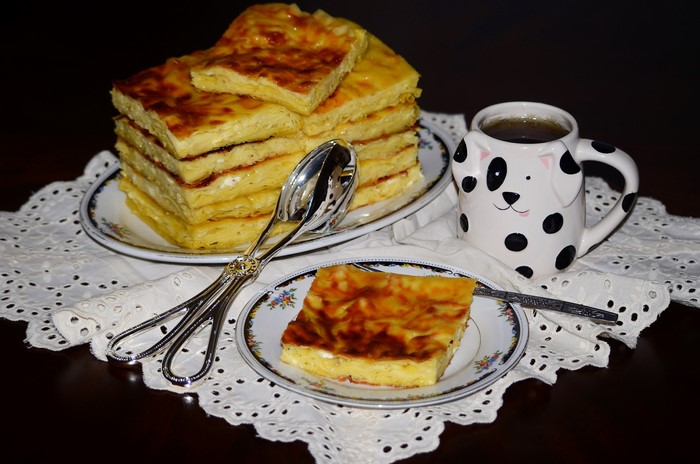 Pastry with tea in a dog-themed mug