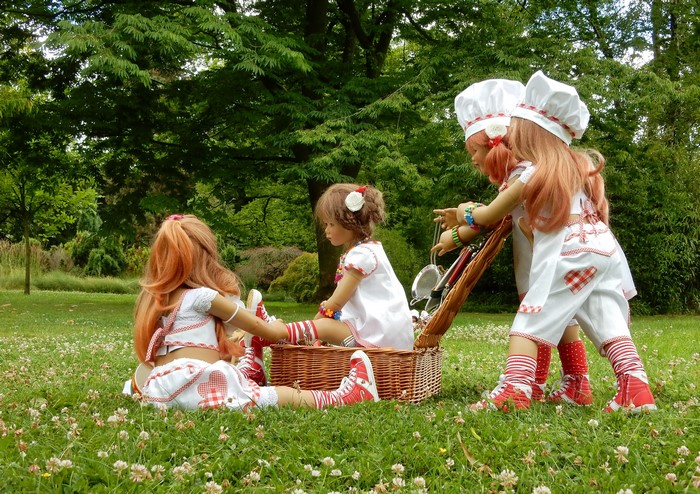 Dolls dressed as cooks in a park